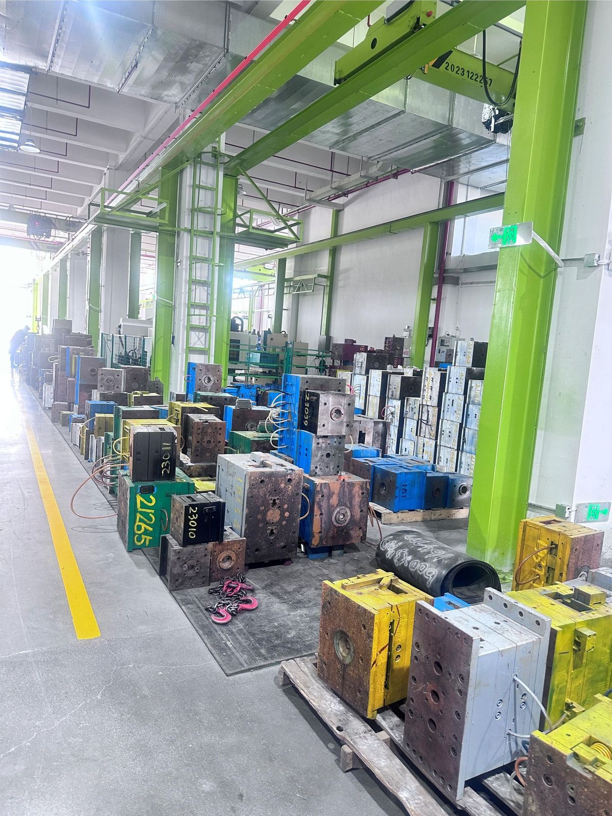 Numbered mould tools on pallets in the mould stores, jib cranes overhead